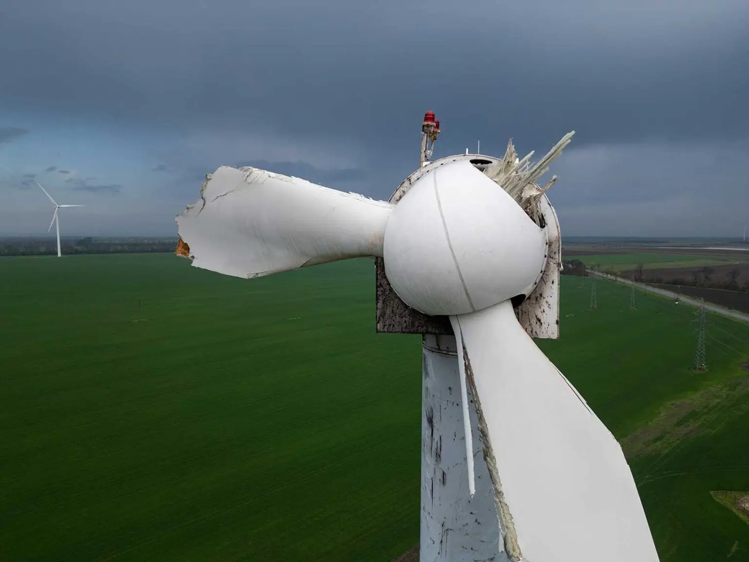 A closeup of a wind turbine that has had it's turbine blades broken off