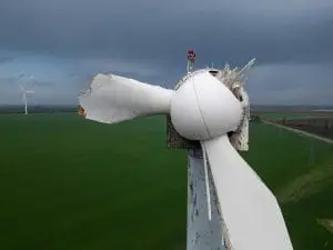 A closeup of a wind turbine that has had it's turbine blades broken off