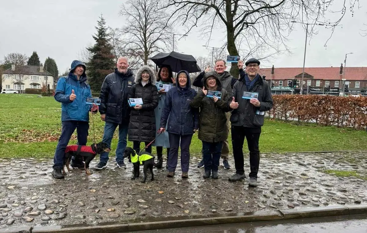 Campaigners for Reform standing in the rain somewhere in Gorton