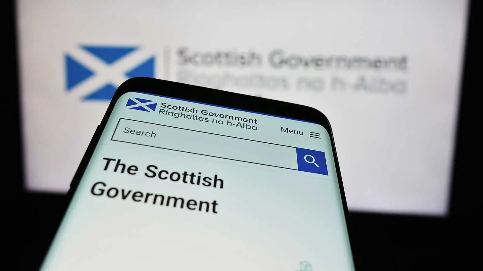 A close-up of a mobile phone screen which has the Scottish Government website displayed on the phone