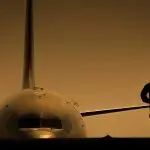 Passenger aircraft on runway at sunset