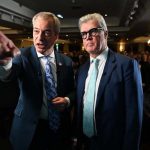 Nigel Farage pointing as he stands next to Malcolm Offord