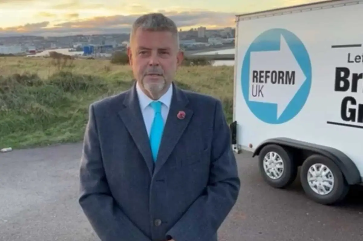 reform candidate standing next to a reform trailer box