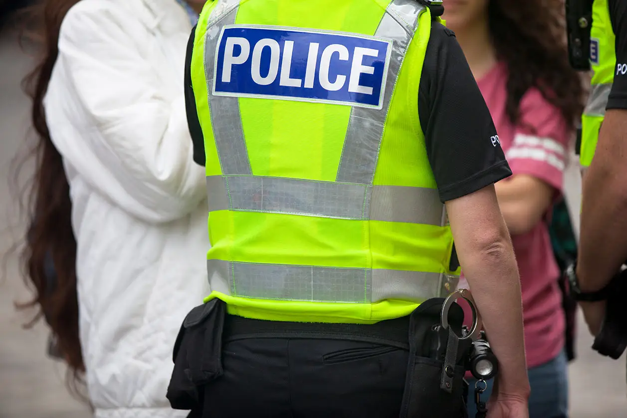 Police talking to unidentified individual on the street