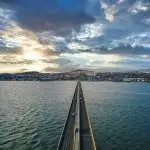 View along the Tay Road Bridge toward Dundee at sunset, with traffic crossing over the River Tay