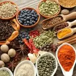 Aromatic spices in metal and ceramic bowls.