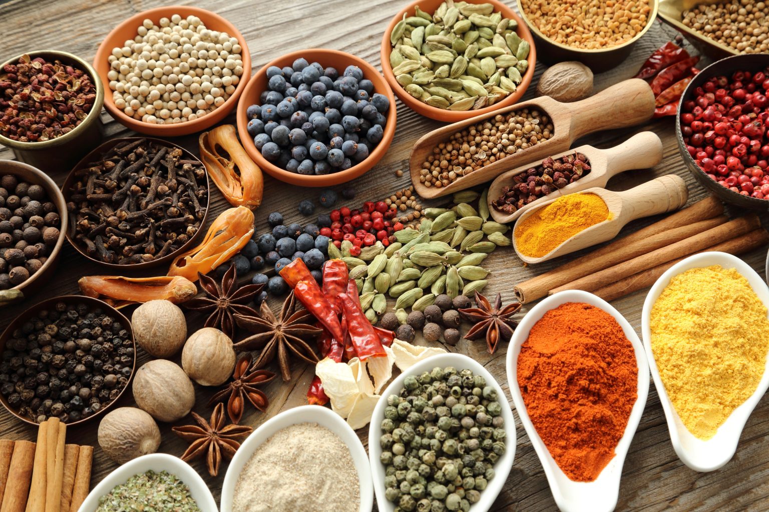 Aromatic spices in metal and ceramic bowls.